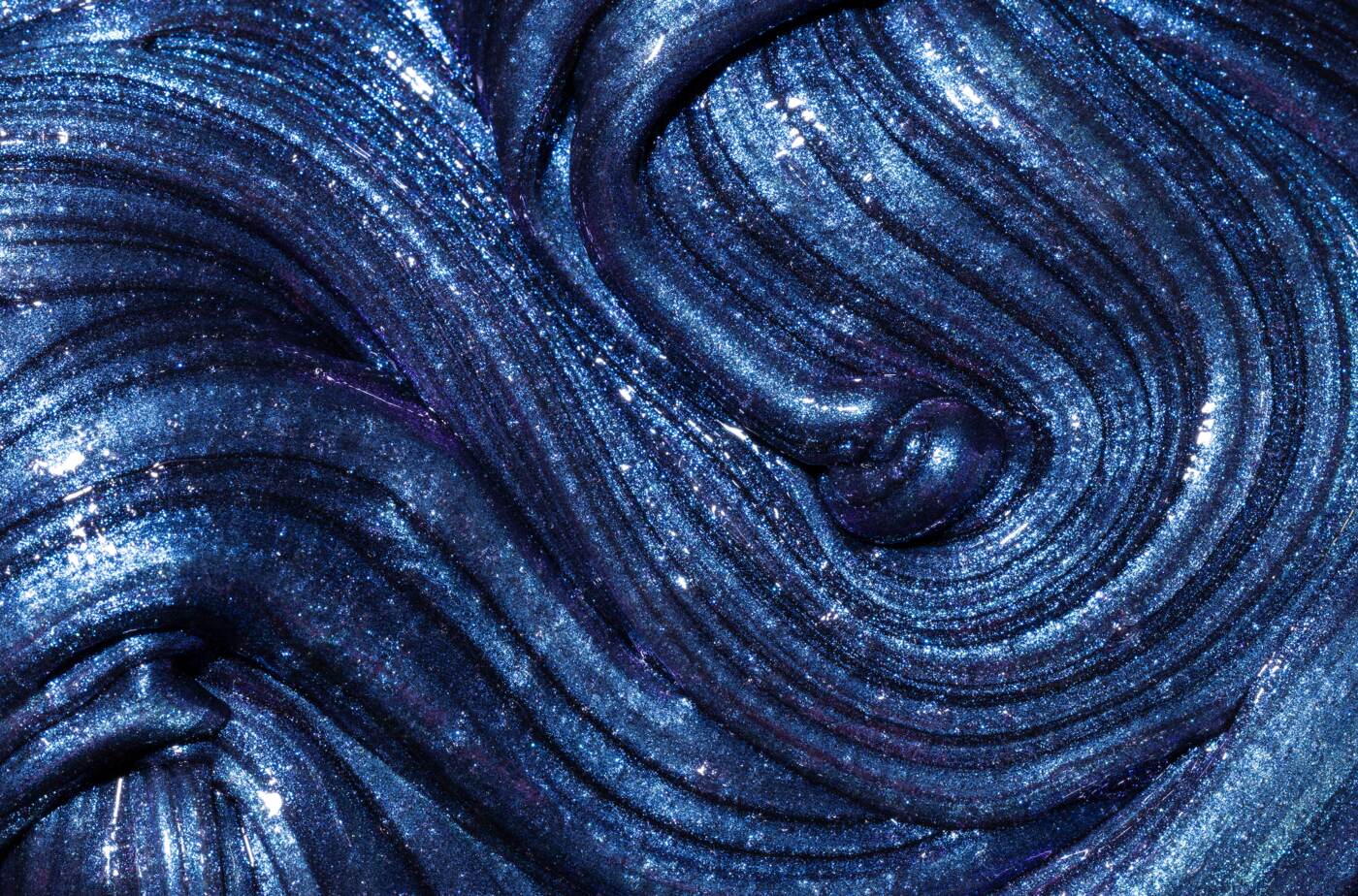 Macro detail of Elmer's Cosmic Shimmer slime with blue and purple swirls