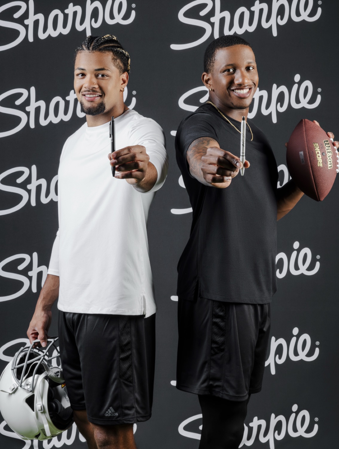 Year 1 rookies on the Sharpie step-and-repeat with pens and football