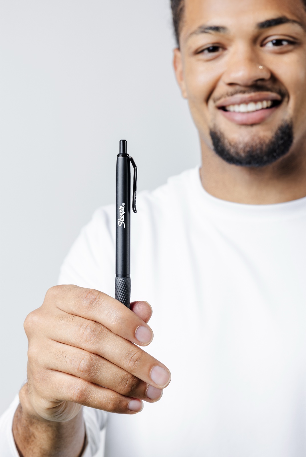 Athlete holding a Sharpie S-Gel pen up to camera
