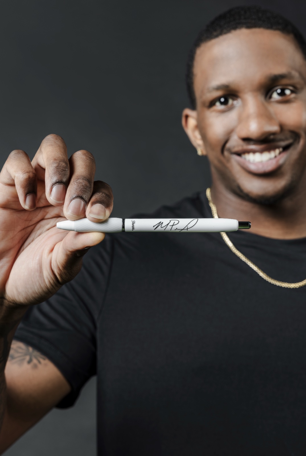 Athlete holding a freshly autographed Sharpie S-Gel